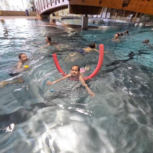 Schwimmende Kinder mit und ohne Schwimmnudel